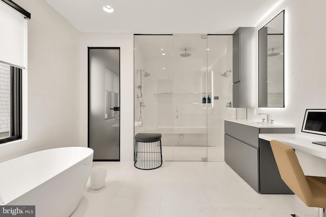 bathroom with recessed lighting, a shower stall, marble finish floor, vanity, and a soaking tub
