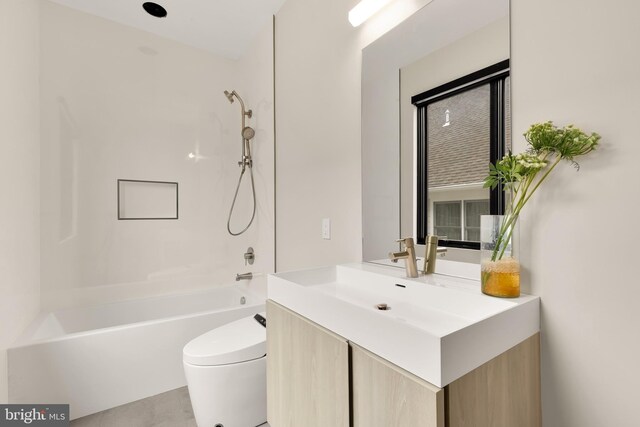 bathroom featuring toilet, vanity, and shower / washtub combination