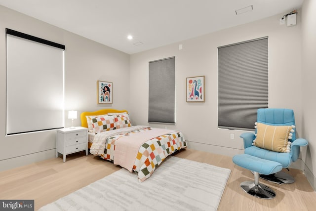 bedroom featuring wood finished floors and recessed lighting