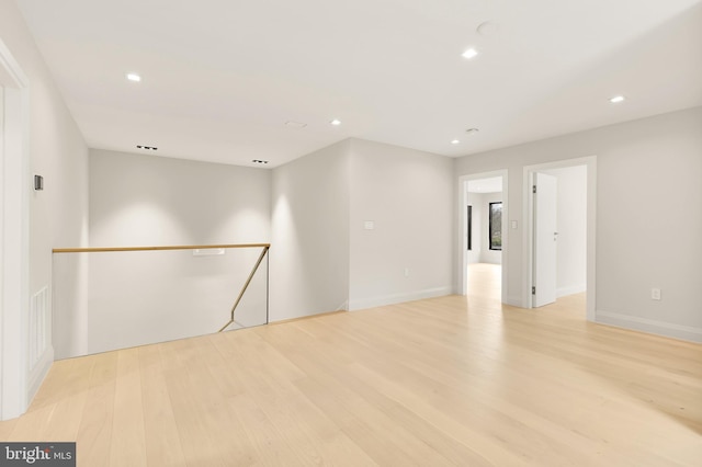 spare room with recessed lighting, visible vents, light wood finished floors, and baseboards
