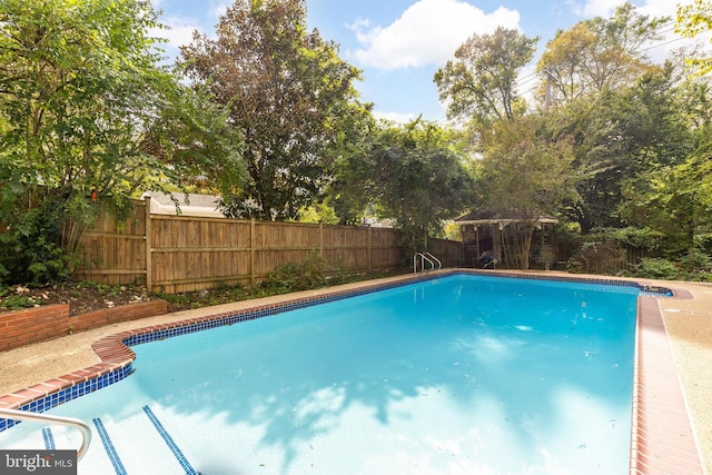 view of swimming pool with a gazebo, fence, and a fenced in pool