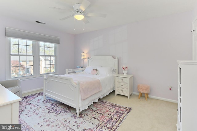 bedroom with baseboards, ceiling fan, light carpet, and visible vents