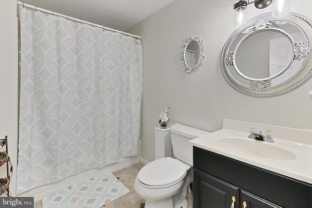 bathroom featuring vanity, a shower with shower curtain, tile patterned floors, and toilet