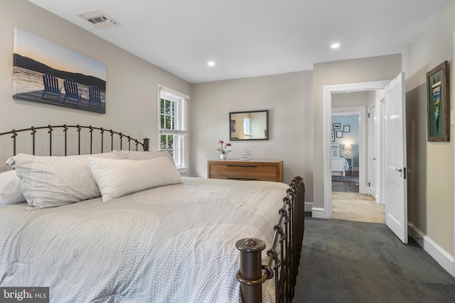 bedroom featuring dark carpet, baseboards, and recessed lighting