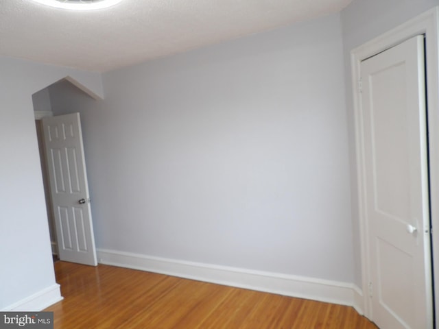 unfurnished room featuring light wood-style flooring and baseboards