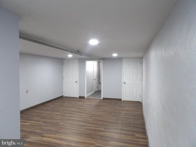 finished below grade area with baseboards, wood finished floors, and recessed lighting