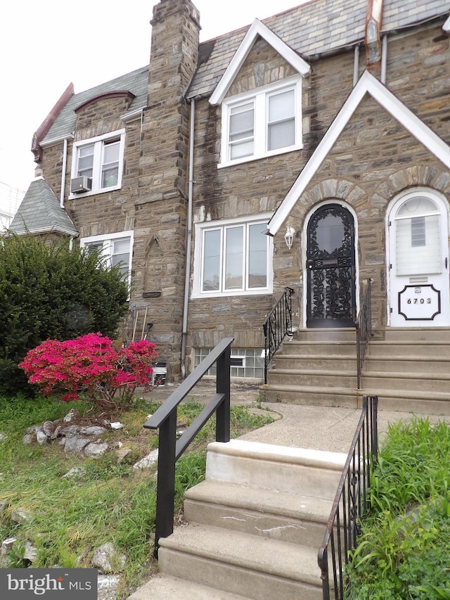 view of front of house featuring cooling unit and stone siding