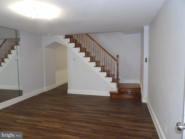 stairs featuring baseboards and wood finished floors