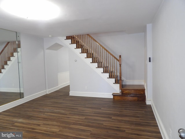 interior space with baseboards and wood finished floors
