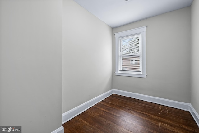 empty room with wood finished floors and baseboards