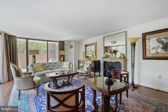 4200 Massachusetts Ave NW Unit 106, Washington, DC 20016 - living area featuring a fireplace, wood finished floors, baseboards, and crown molding