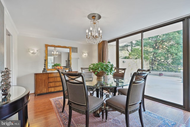 4200 Massachusetts Ave NW Unit 106, Washington, DC 20016 - dining area with a chandelier, crown molding, and light wood-type flooring