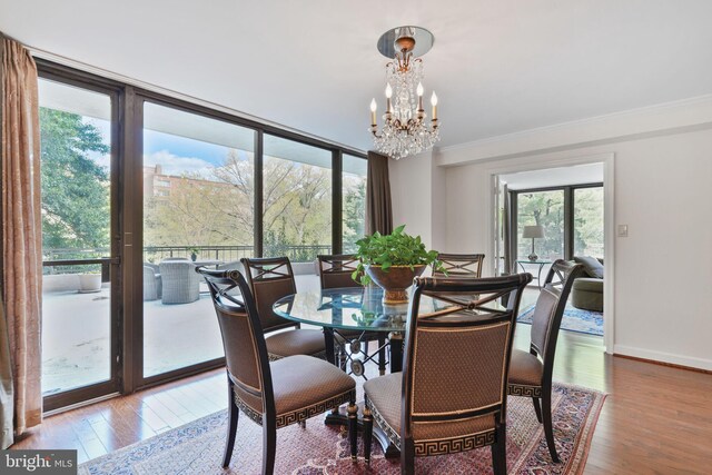 4200 Massachusetts Ave NW Unit 106, Washington, DC 20016 - dining area featuring a chandelier, wood finished floors, crown molding, and baseboards