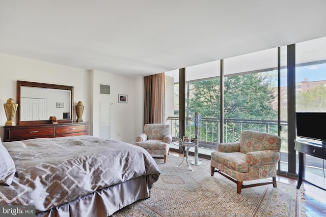 4200 Massachusetts Ave NW Unit 106, Washington, DC 20016 - bedroom with multiple windows, expansive windows, and wood finished floors
