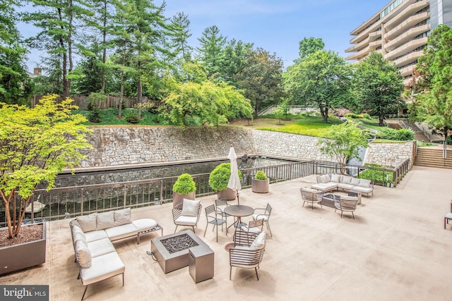 4200 Massachusetts Ave NW Unit 106, Washington, DC 20016 - fenced backyard with an outdoor living space with a fire pit and a patio