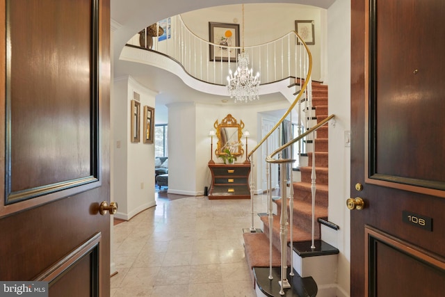 4200 Massachusetts Ave NW Unit 106, Washington, DC 20016 - entrance foyer featuring stairs, a chandelier, a high ceiling, baseboards, and light tile patterned floors