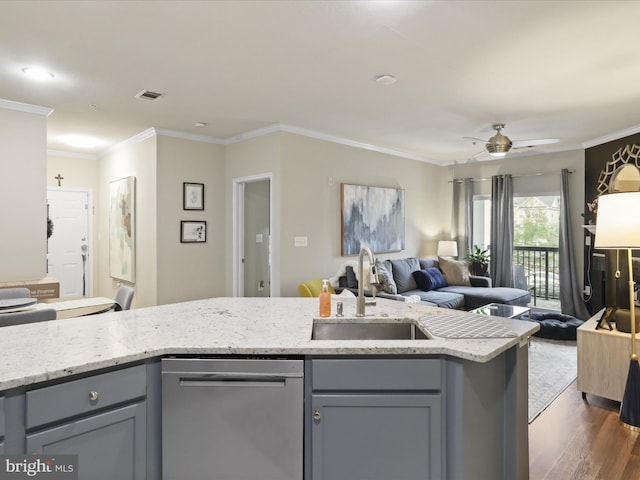 kitchen featuring visible vents, stainless steel dishwasher, a sink, gray cabinetry, and open floor plan