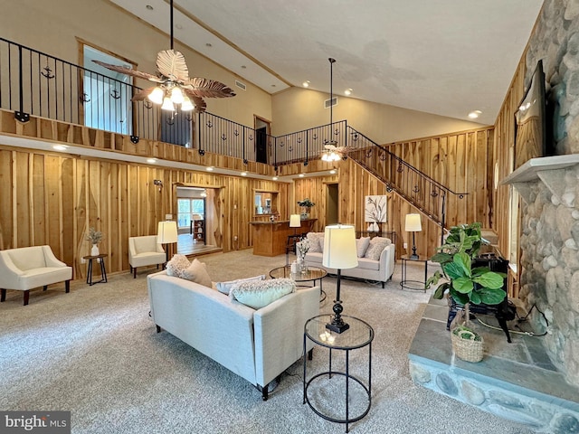 18855 Wicomico River Dr, Cobb Island, MD 20625 - living room with stairway, wooden walls, a ceiling fan, a fireplace, and carpet flooring