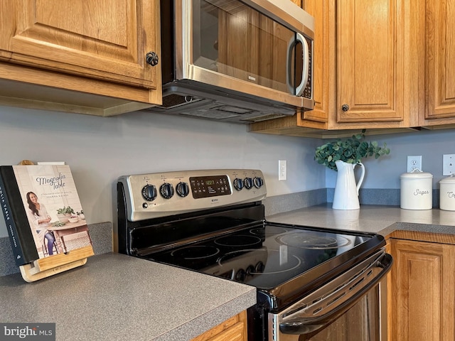 18855 Wicomico River Dr, Cobb Island, MD 20625 - kitchen featuring brown cabinets and appliances with stainless steel finishes