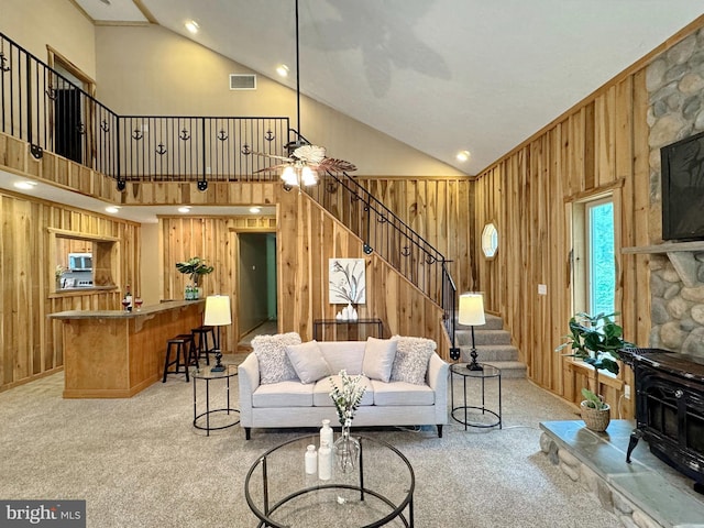 18855 Wicomico River Dr, Cobb Island, MD 20625 - living room with light carpet, wood walls, and high vaulted ceiling