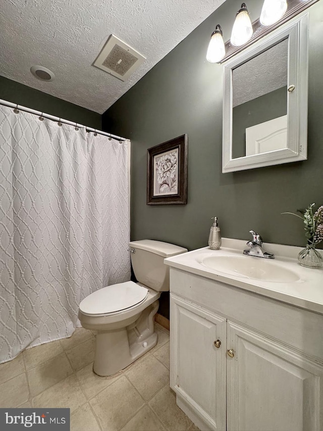 18855 Wicomico River Dr, Cobb Island, MD 20625 - bathroom with tile patterned floors, visible vents, toilet, vanity, and a textured ceiling