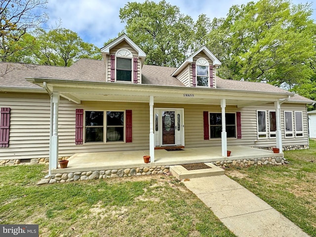 18855 Wicomico River Dr, Cobb Island, MD 20625 - cape cod-style house with a porch, a shingled roof, and a front yard