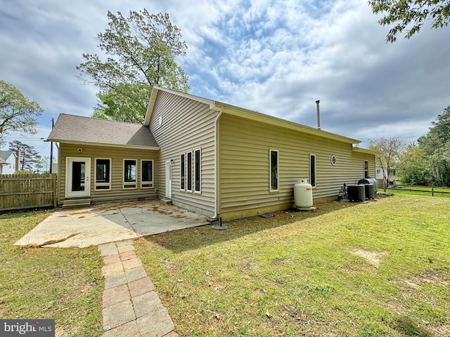 18855 Wicomico River Dr, Cobb Island, MD 20625 - rear view of house with a yard, a patio area, central AC unit, and fence