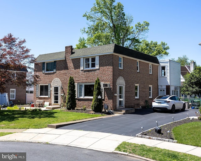 view of front of house with a front lawn and brick siding