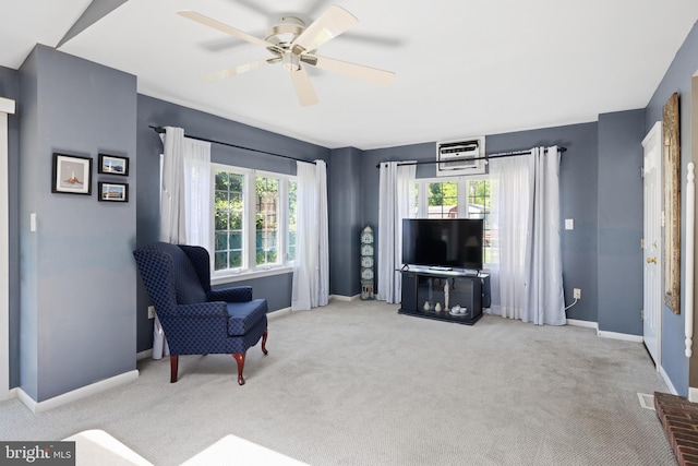living area with carpet floors, baseboards, and ceiling fan