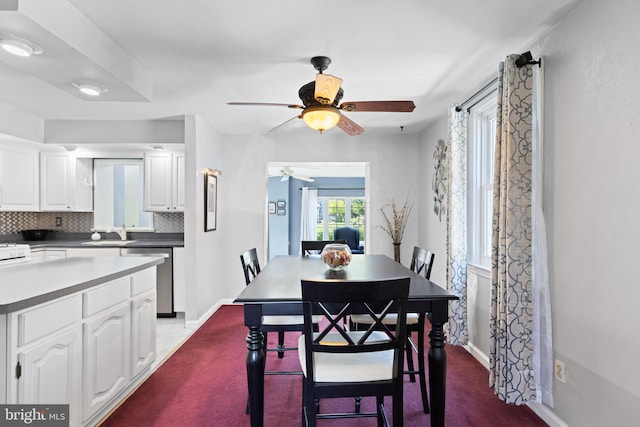 dining room with ceiling fan and baseboards