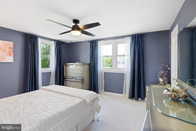 bedroom with carpet, multiple windows, baseboards, and ceiling fan