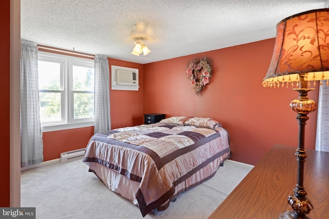 bedroom featuring a baseboard heating unit, an AC wall unit, carpet floors, baseboards, and a textured ceiling