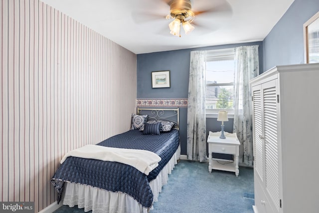 bedroom with carpet floors, wallpapered walls, and a ceiling fan