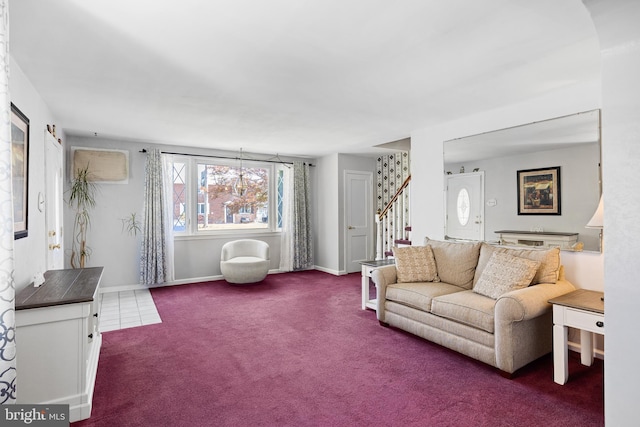 carpeted living area with stairs and baseboards