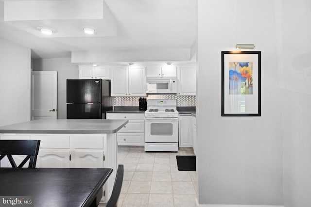 kitchen featuring white appliances, backsplash, and white cabinets