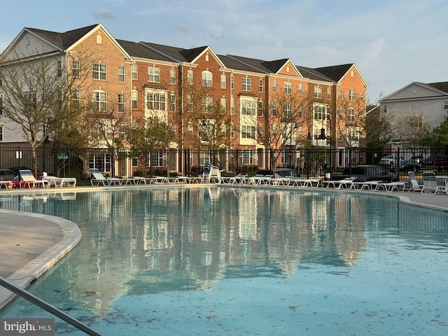 community pool featuring a patio and fence