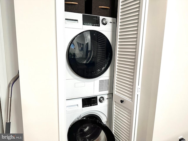 laundry room featuring stacked washer and clothes dryer and laundry area