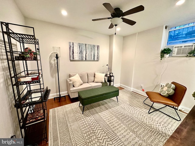 living area featuring baseboards, a ceiling fan, recessed lighting, cooling unit, and wood finished floors