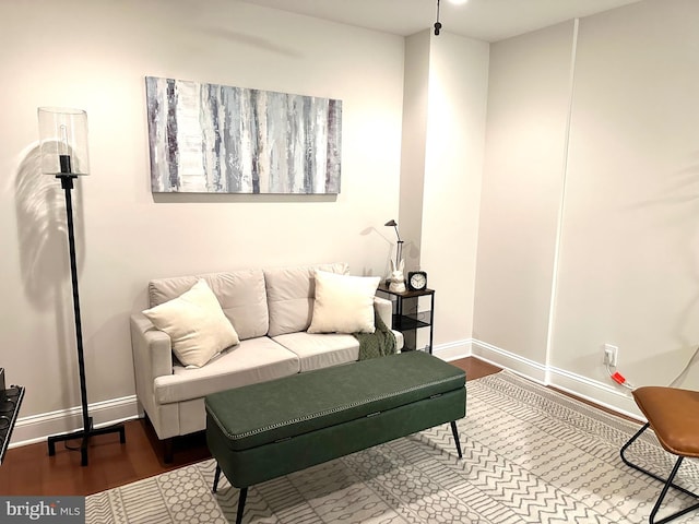 living room with baseboards and wood finished floors