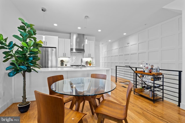 1169 Neal St NE Unit 1, Washington, DC 20002 - dining room with baseboards, recessed lighting, light wood-style flooring, and a decorative wall