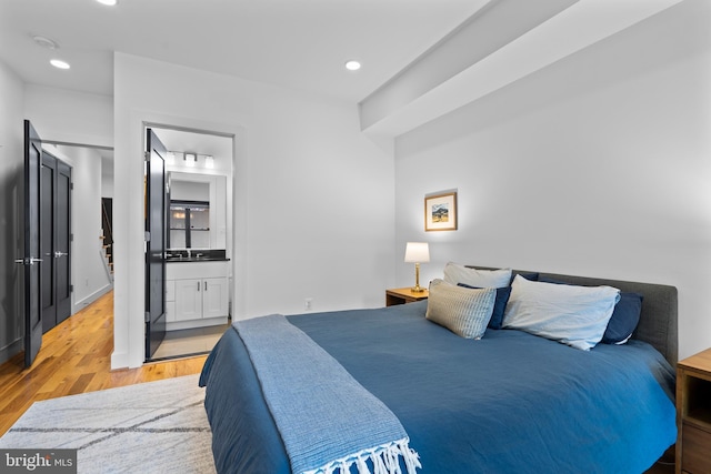 1169 Neal St NE Unit 1, Washington, DC 20002 - bedroom with connected bathroom, recessed lighting, and wood finished floors