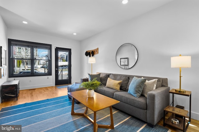 1169 Neal St NE Unit 1, Washington, DC 20002 - living area featuring recessed lighting, baseboards, wood finished floors, and a wood stove