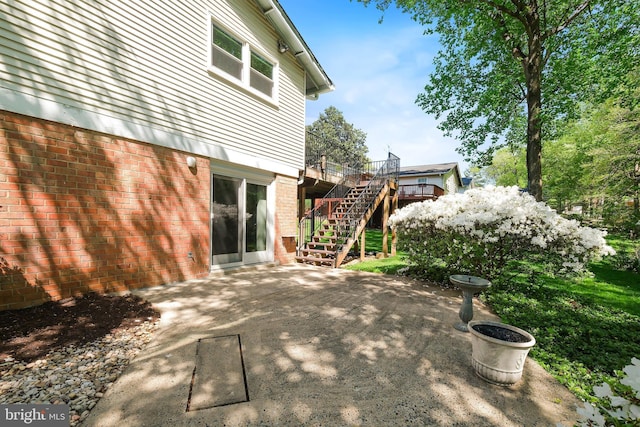 view of patio featuring stairway and a wooden deck