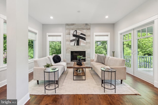 living area with baseboards, recessed lighting, a fireplace, and hardwood / wood-style floors
