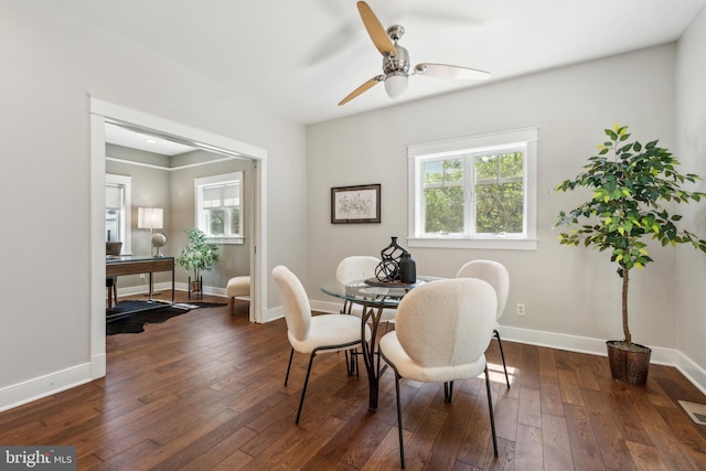 dining area with baseboards, ceiling fan, dark wood-style floors, and visible vents