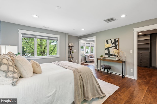 bedroom with recessed lighting, baseboards, visible vents, and wood finished floors