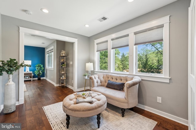 living area with recessed lighting, baseboards, visible vents, and dark wood-type flooring