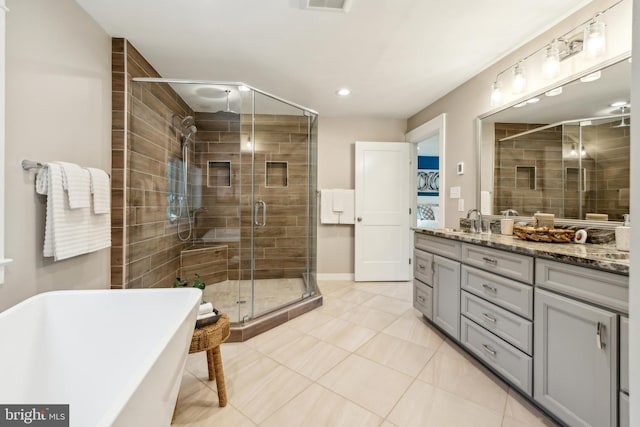 full bathroom featuring vanity, visible vents, a freestanding tub, tile patterned floors, and a stall shower