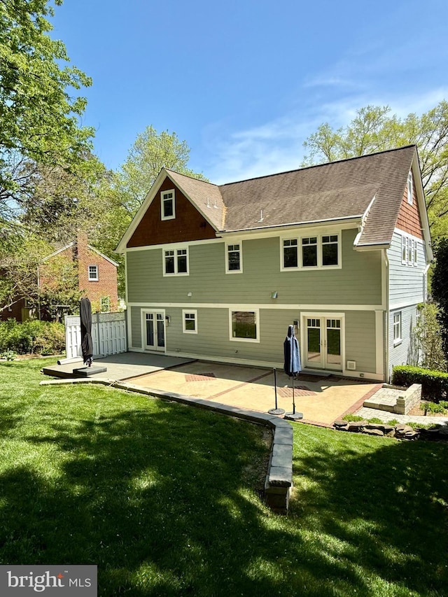 rear view of property with a lawn, a patio, and french doors