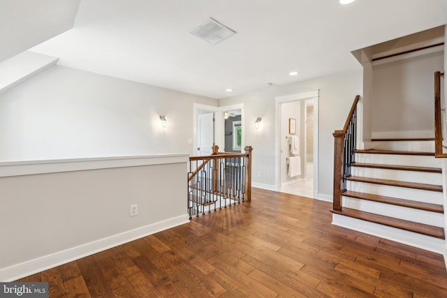 interior space featuring recessed lighting, baseboards, visible vents, and hardwood / wood-style floors